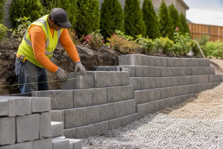 Contractor building a block retaining wall